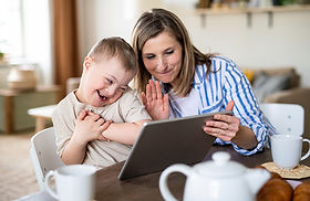 Mother and child with down syndrome logging in for online speech therapy session