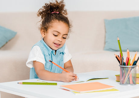Child working on coloring and writing skills in occupational therapy