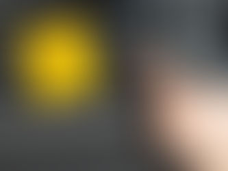 A hand typing on a keyboard which has a yellow post it with Hello! and a smiley face on it