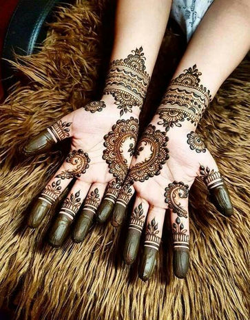 Mehndi (henna) hand mandala designs in India