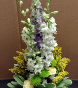 Tall white, purple, yellow, and green basket arrangement