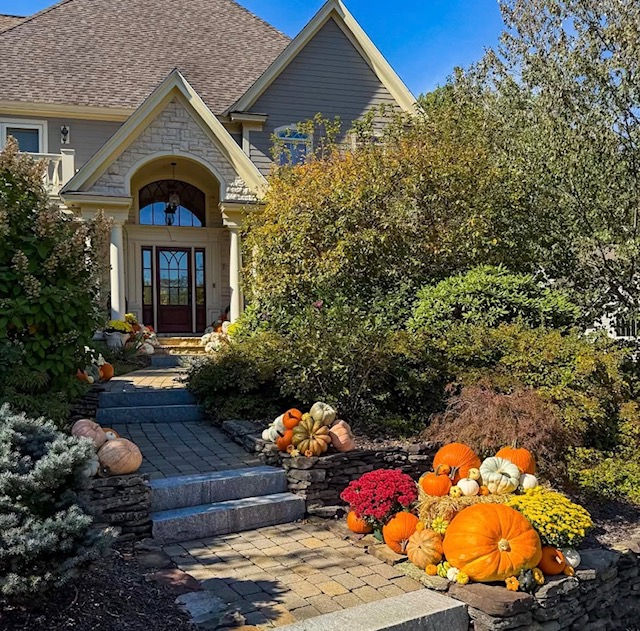 Festive autumn porch decoration with pumpkins and warm lighting