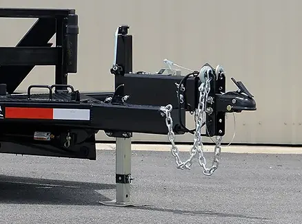 tongue of trailer with adjustable coupler, safety chains, and drop leg jack.