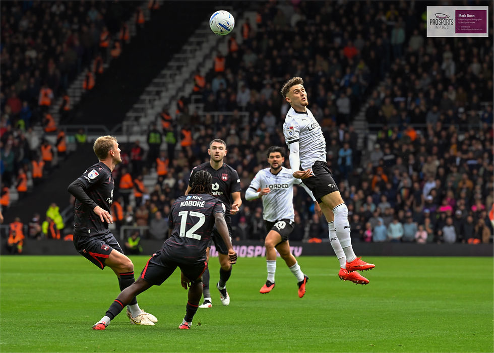 Derby County's Sammie Szmodics heading the ball towards the goal - Photograph by Mark Dunn