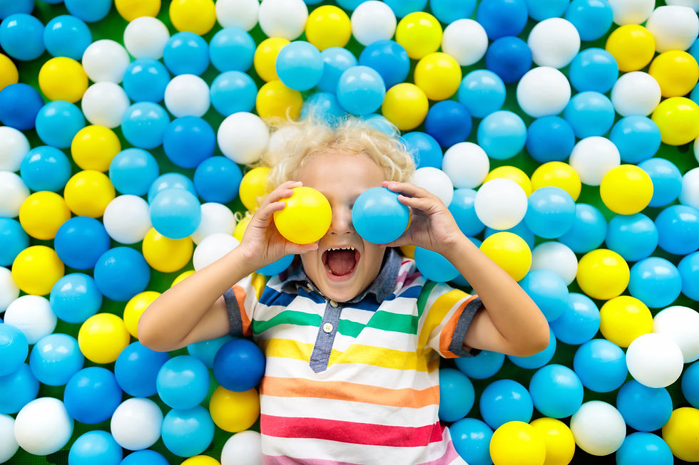 kid playing in a ball pit