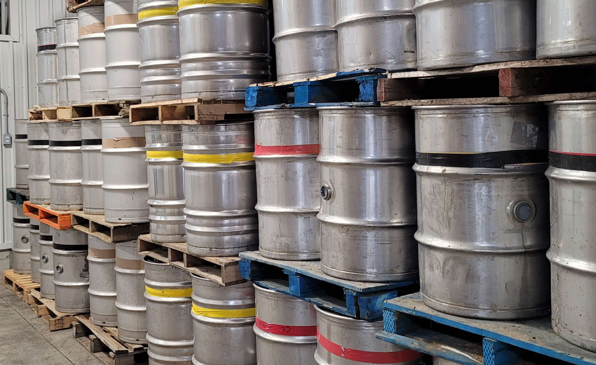 Metal barrels of maple syrup at Voisin's Maple Products factory.