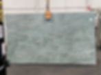Green Esmeralda quartzite slab held by fork lift