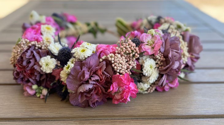 Handmade lei po’o or haku flower crown with dark purple and pink flowers for special occasions in Gilbert, Arizona
