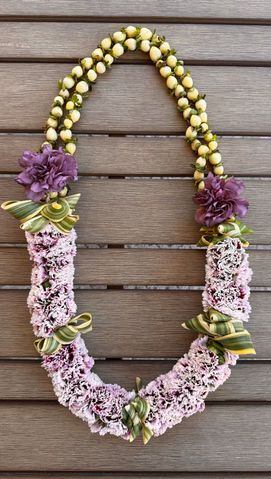 Carnation lei with variegated Song of India leaves and red hypericum berries, creating a lush and colorful tropical arrangement.