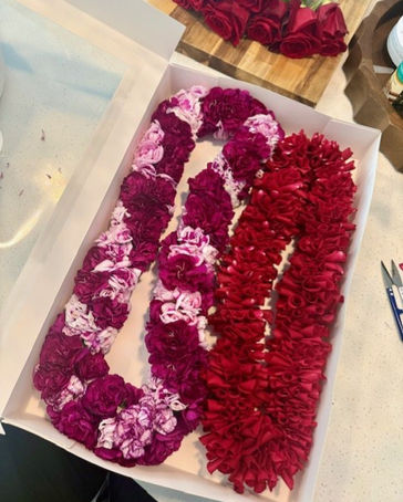 Purple and white carnation spiral lei with a rose lei handcrafted in Gilbert, Arizona for graduations and special occasions