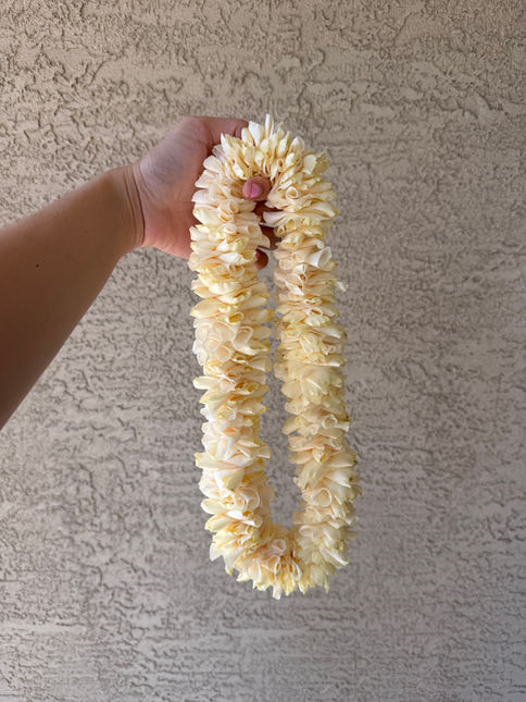 Elegant white rose wedding lei handcrafted in Gilbert, Arizona for ceremonies and special occasions
