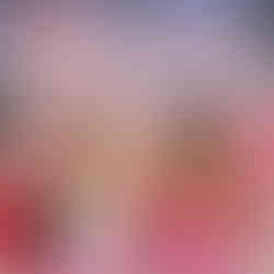 Two women laugh, holding drinks, against a tropical "MADE FOR KISSING" backdrop. They're seated on pink cushions, creating a vibrant, fun mood. Similar to the confessional backdrops in love island usa.