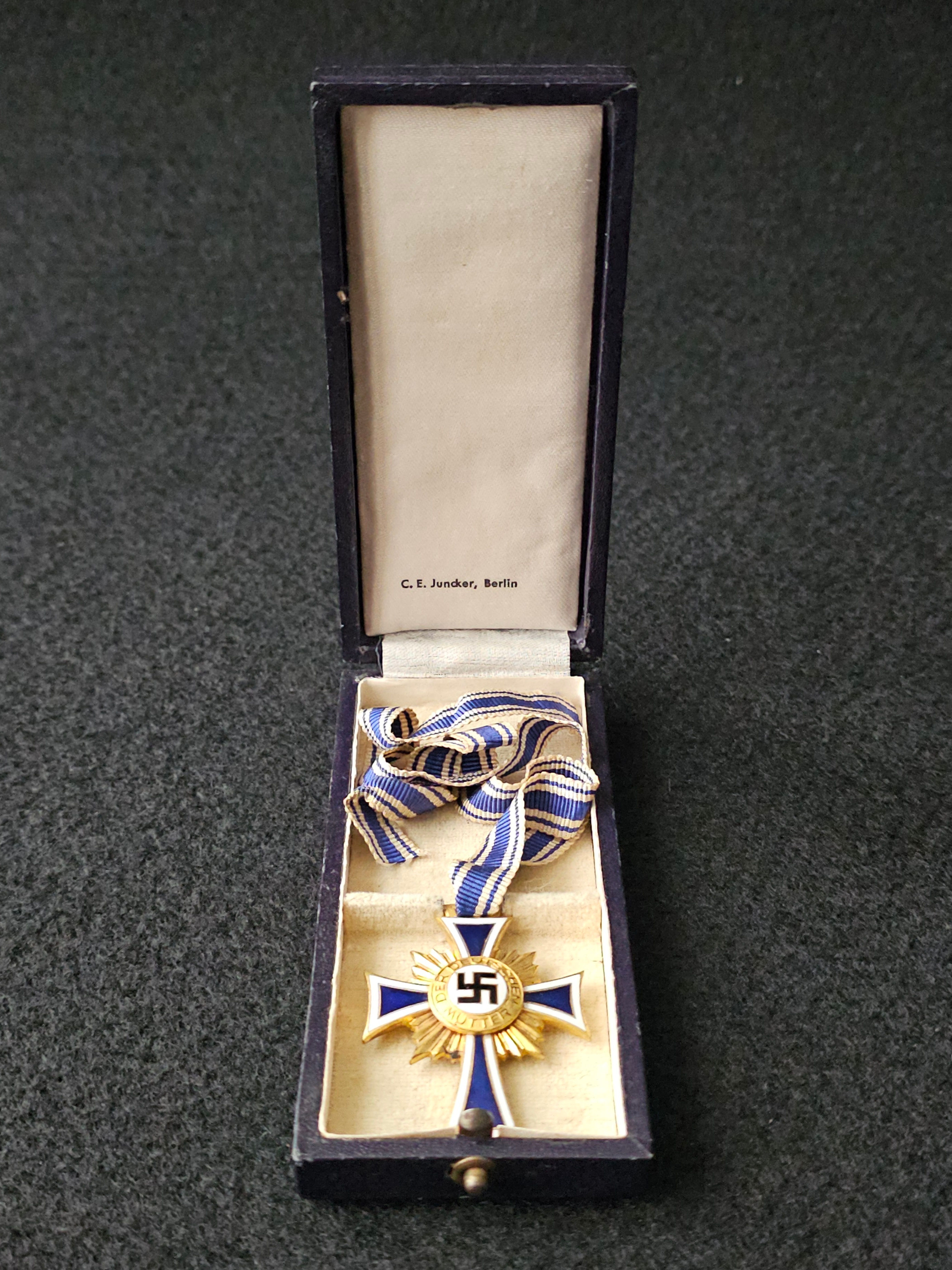 Mother cross in gold in box by C.E. Juncker in box.