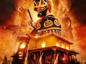 Poster for Hallowarrior (2026) on Shudder. A large, old house with beings draped in white sheets in the yard, and multiple characters in the background of orange and black