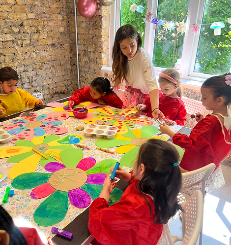 Children follow art teacher's instructions
