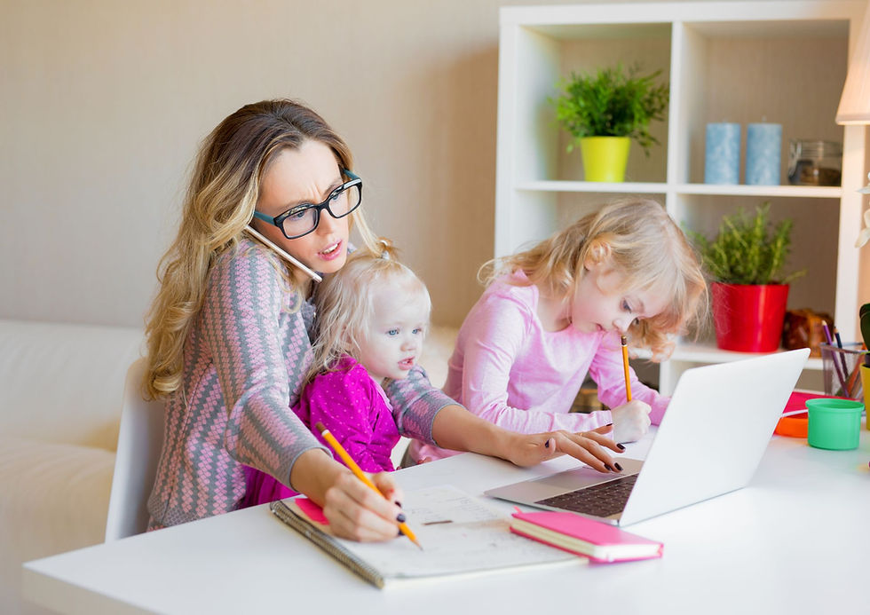 Busy mum on the phone, working on laptop - juggling working and looking after 2 children.