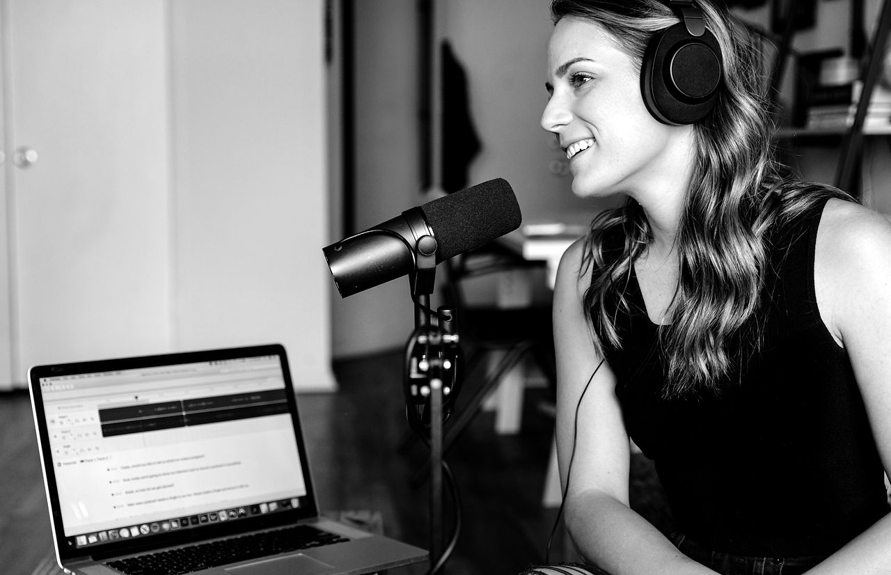 woman in black tank top sitting on chair in front of microphone_edited.jpg