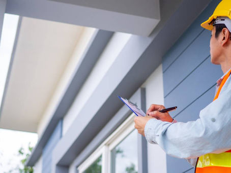 A roofer inspecting a residential roof near Columbia, SC