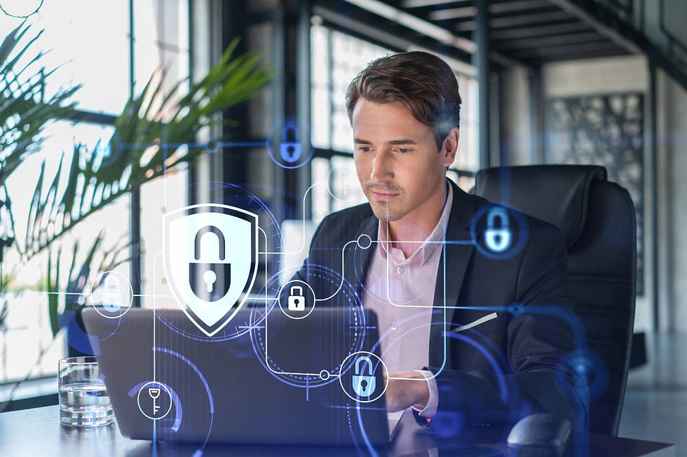 Man in a suit sitting at a desk typing at his laptop with a cybersecurity graphic in the foreground.