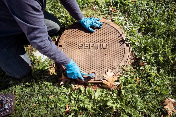 An inspector looking into a septic tank near Lexington, Kentucky (KY)