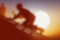 silhouette-of-a-roofing-contractor-on-a-roof-laying-shingles-during-roof-replacement-1200p