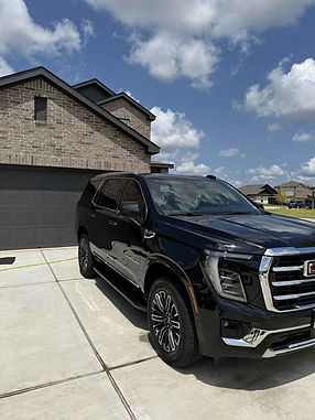 Shiny black GMC SUV after mobile auto detailing by Kurtz Auto Detailing, with polished paint and a spotless exterior finish.