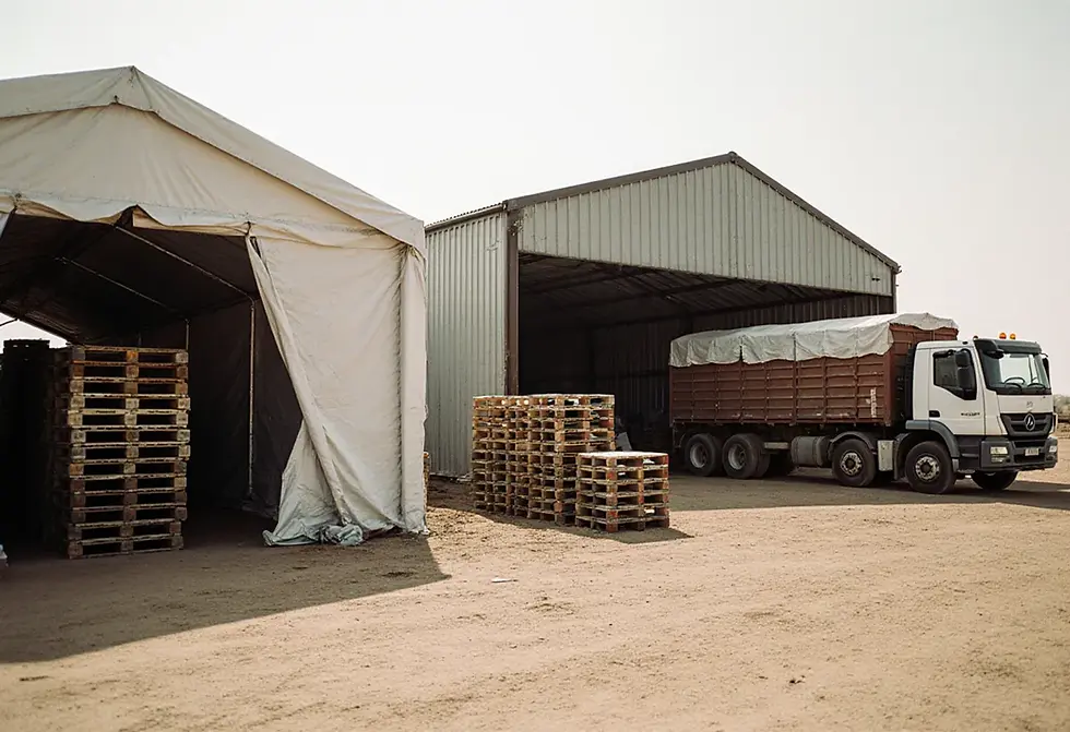 A modular rapid-deploy warehouse alongside a permanent store in South Sudan