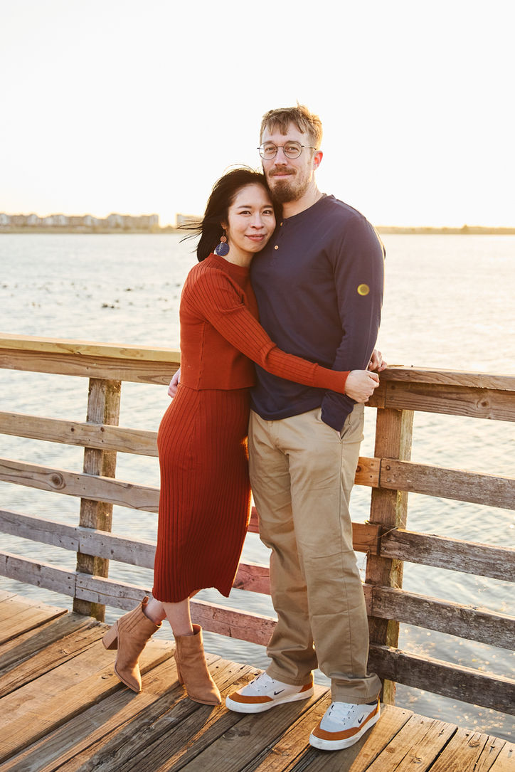 Couple hugging on a wooden dock during a relaxed Austin couples photography session