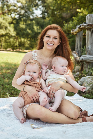 Bull Creek District Park family photos of a mother sitting with her twin baby girls during a summer family photo session