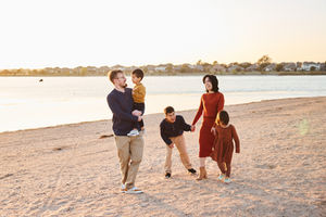 Family walking together at Lake Pflugerville Park during golden hour, North Austin family photo session