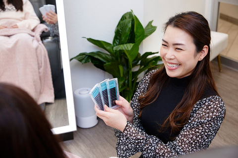Business owner smiling while consulting a client, human-focused branding photography indoors