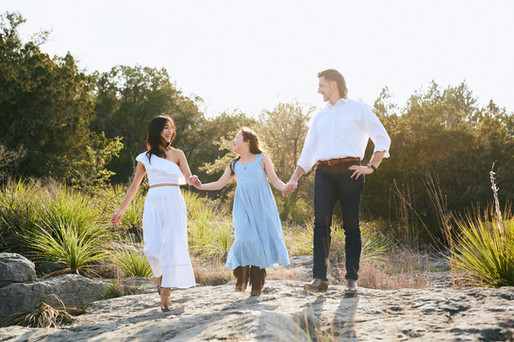 Family walking together on limestone rocks at Pedernales Falls State Park, natural family photography near Austin