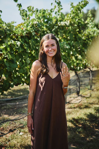 Happy newly engaged woman showing her ring at Camp Lucy Vineyard Dripping Springs TX.