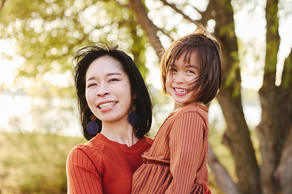 Mother and child smiling during a family photo session at Lake Pflugerville Park near Austin