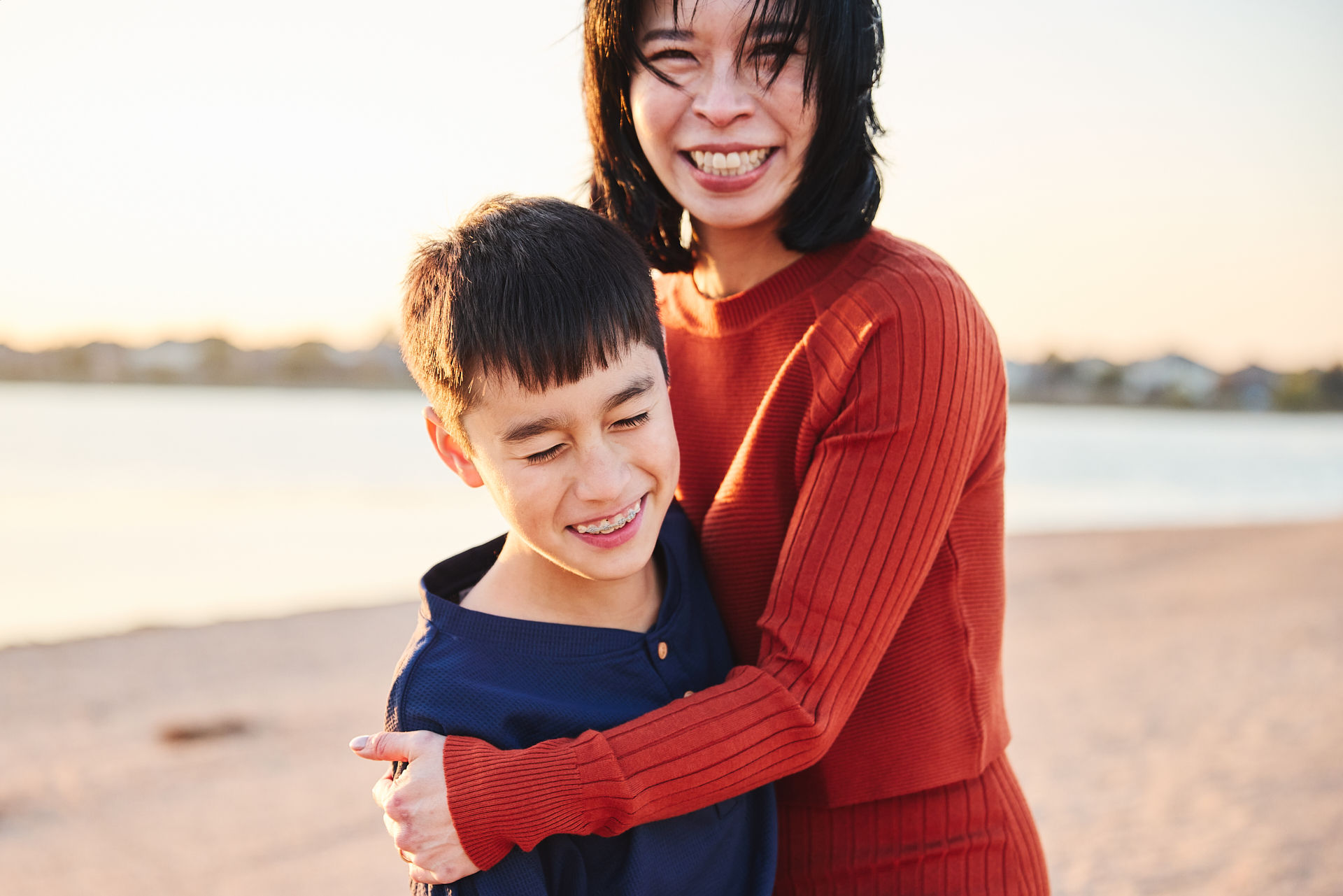 Mother and child smiling during a family photo session at Lake Pflugerville Park near Austin