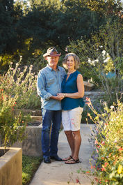 A happy couple standing together at Sunken Garden in Georgetown TX during their anniversary morning photoshoot.