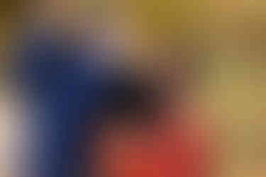 Family hugging and laughing during a natural family photo session at Lake Pflugerville Park