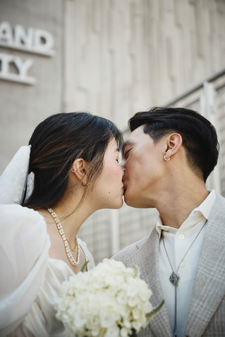 Close-up kiss of a couple outside the Travis County Courthouse in downtown Austin after their courthouse wedding