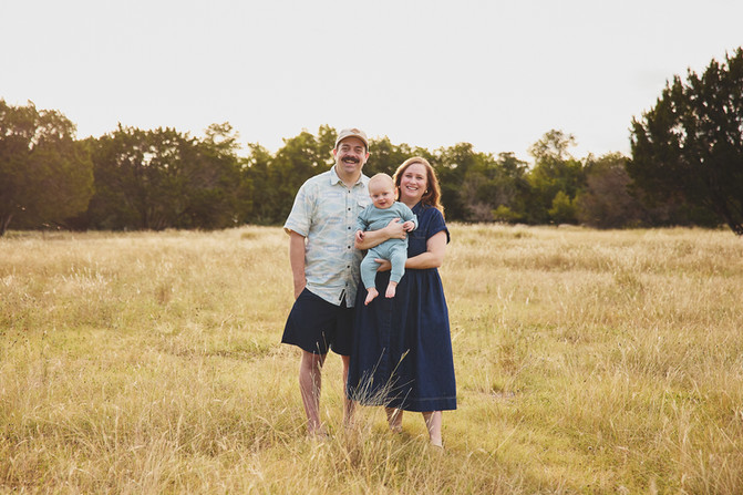 Family of three with a baby boy laughing at Mary Moore Searight Metropolitan Park.