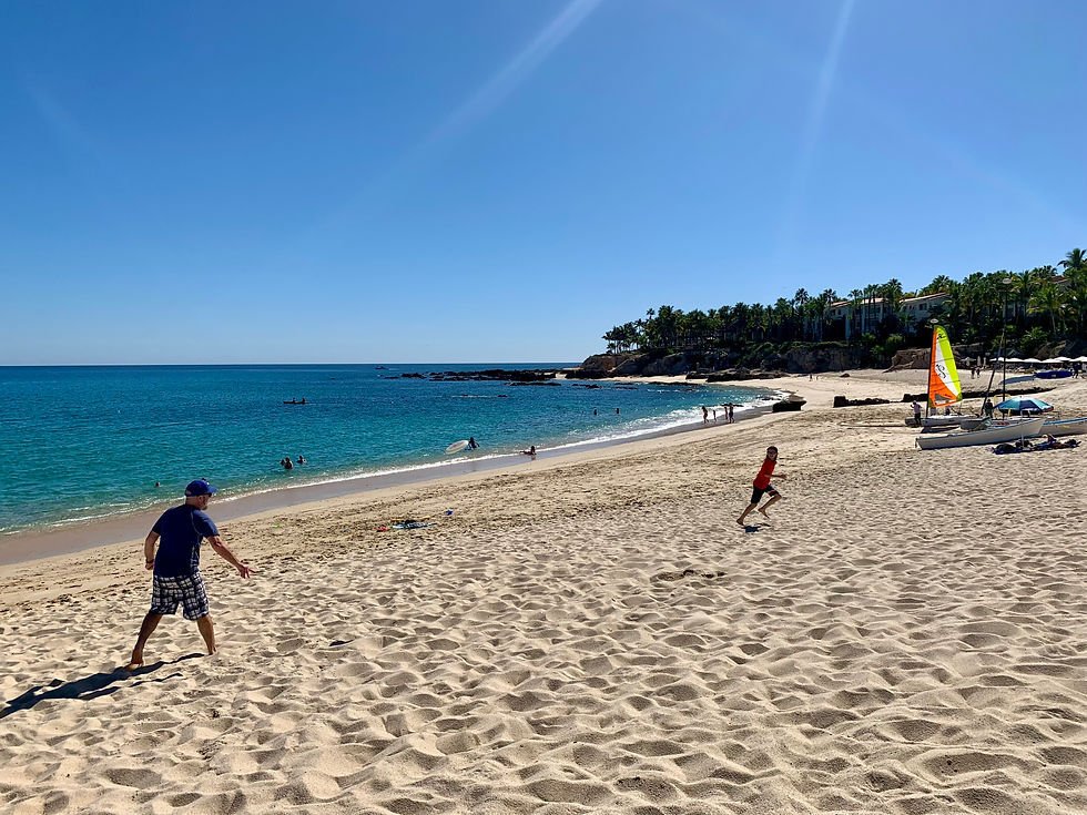 My husband and son playing frisbee at Palmilla Beach. One&Only Palmilla is located directly on this beach and if you book with me I can get you extra perks you won't get booking on your own.