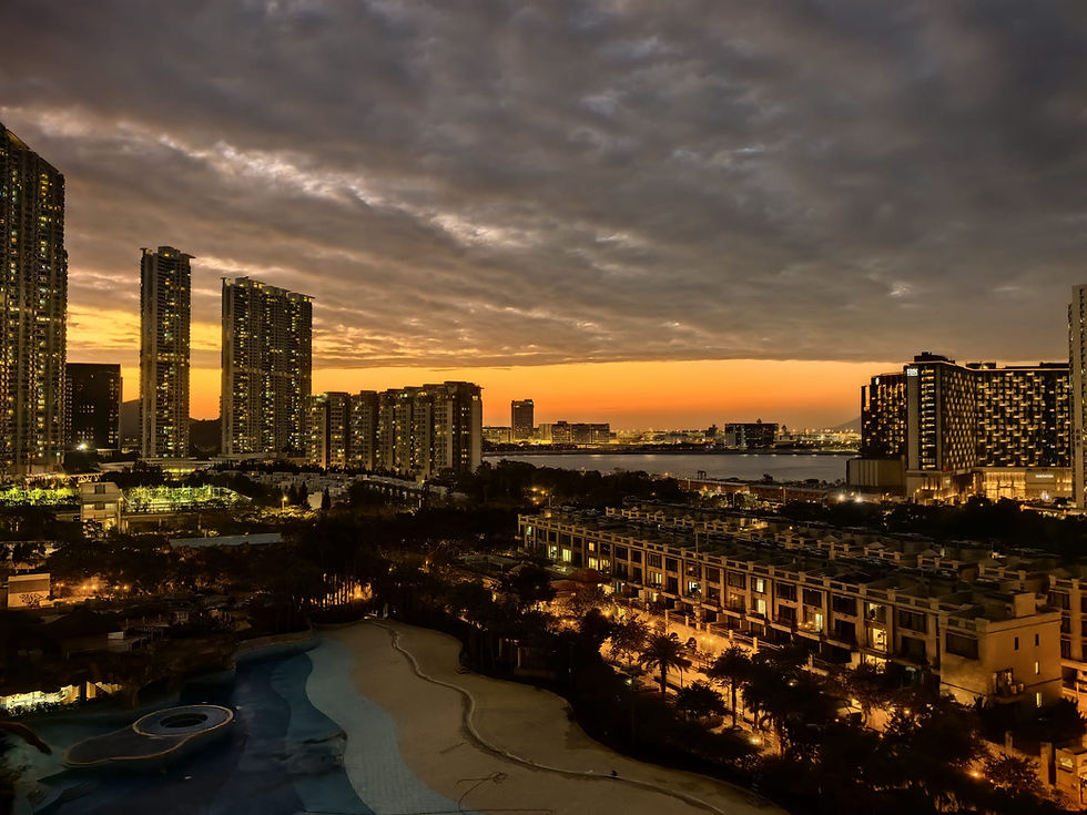 Eye-level view of Tung Chung waterfront promenade with residential buildings and mountains in the background