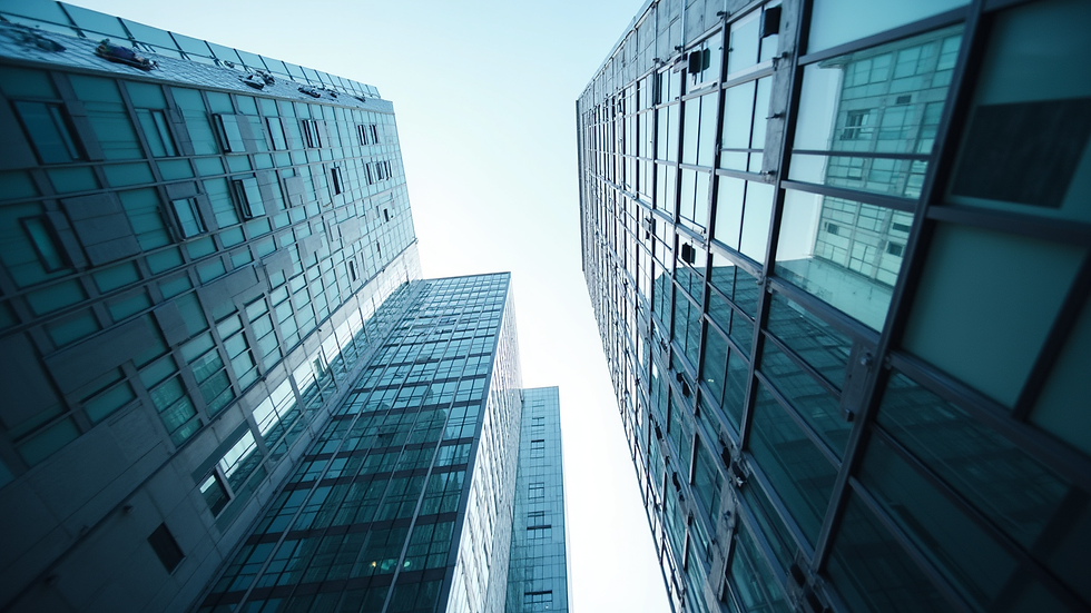 Eye-level view of a modern office building representing corporate investment opportunities