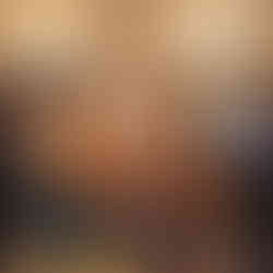 Bride and groom laughing with guests at bar