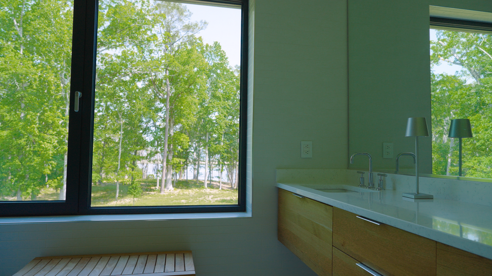 Interior view of a modern bathroom at the Nevills Creek House, showcasing a large black-framed Passive House window