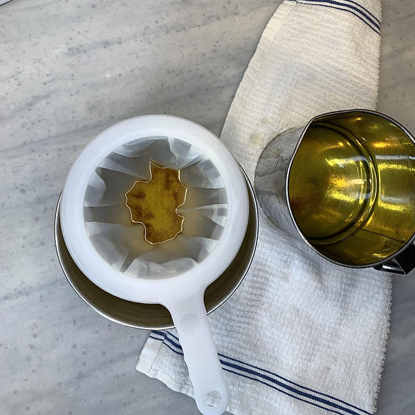 Using an ultra-fine strainer to get out the smallest bits of fat.