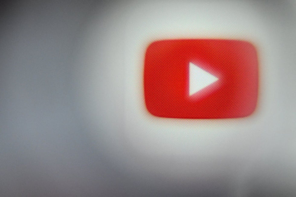 Close-up of the YouTube logo featuring the iconic red play button against a blurred background, symbolizing the platform's global influence in video sharing and content creation.