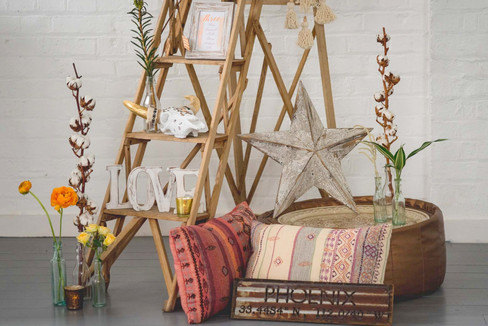 Vintage Wooden Lattice Ladder, Resin Skull, Table Plan Frames, LOVE sign, and Southwestern Star, Copper Pouffe, Boho Cushions, Gold and Bronze Tea Light Holders at The Winding House, Kent