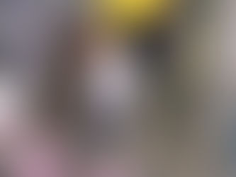 Boy in hospital room holding stick to hit pinata