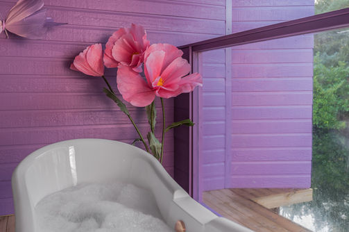 rainfall shower over bath at on balcony at Alice’s Secret Garden glamping pod, Wonderland Retreats