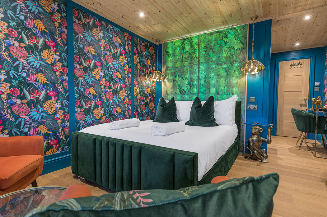 Plush king-size bed with luxury linens inside Monkey Manor pod at Hidden Hills Glamping.